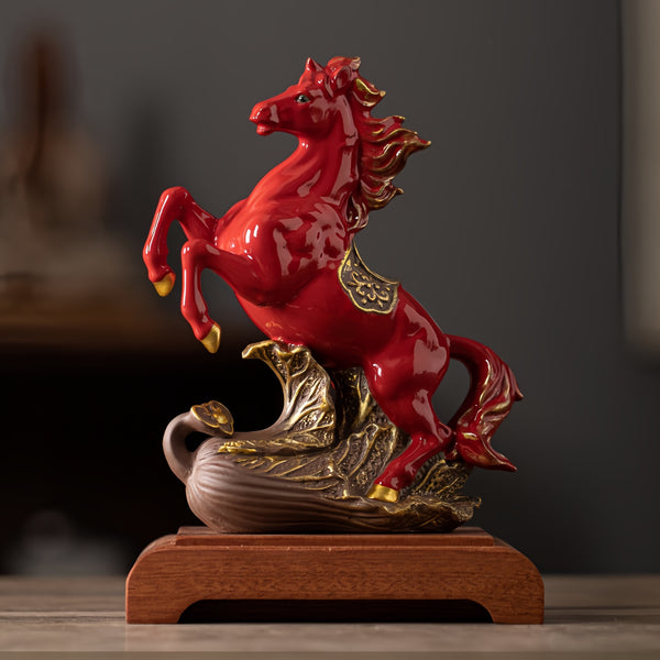 Red ceramic horse figurine on a wooden base with a dark background