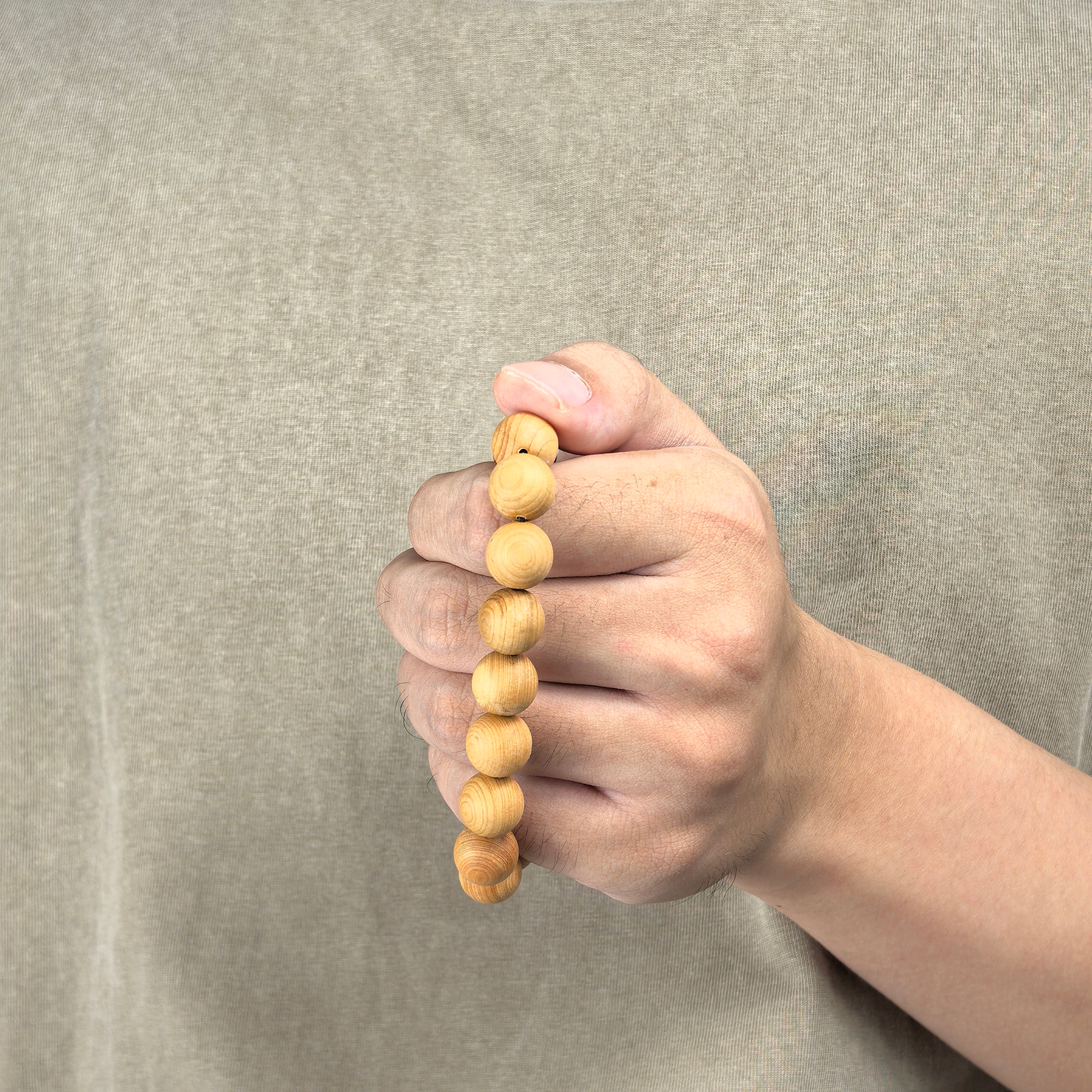 Holding a Thuja Wood Bracelet - KarmaBless